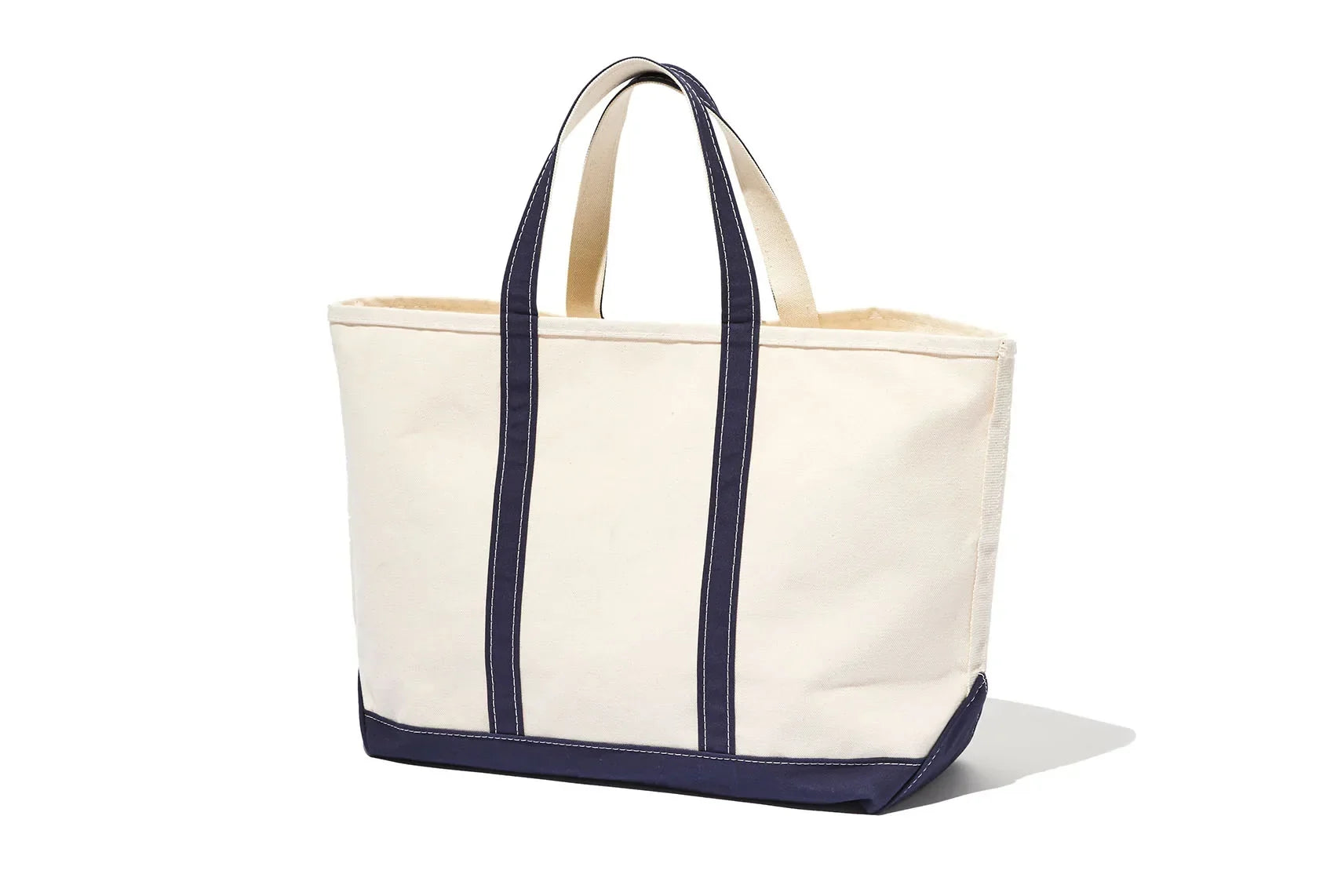 Cream canvas tote bag with navy blue handles and trim