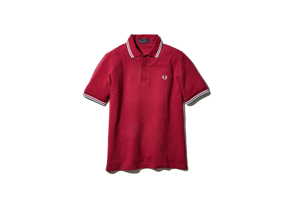 Red polo tee shirt with white border on the sleeve and FRED PERRY logo