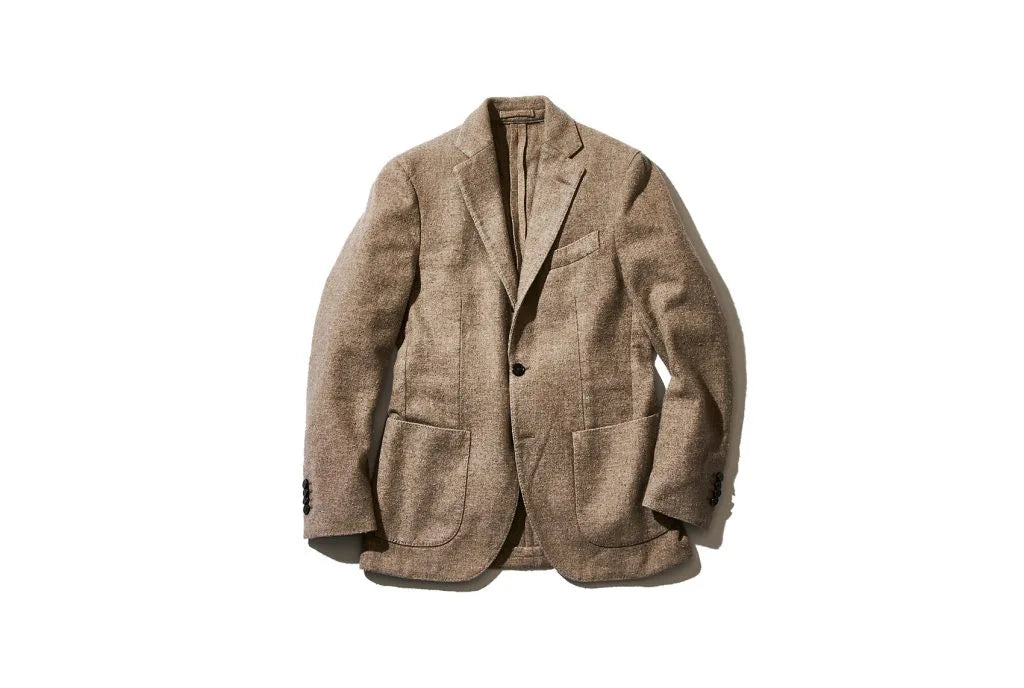 Beige textured blazer with notched lapels, one-button closure, chest pocket, and two front patch pockets