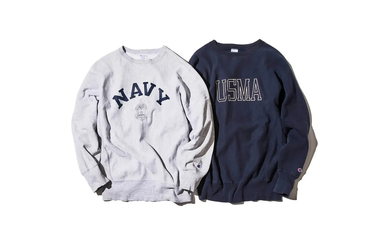 a gray Champion sweater on the left that says "Navy" and a blue sweater on the right that says "USMA"