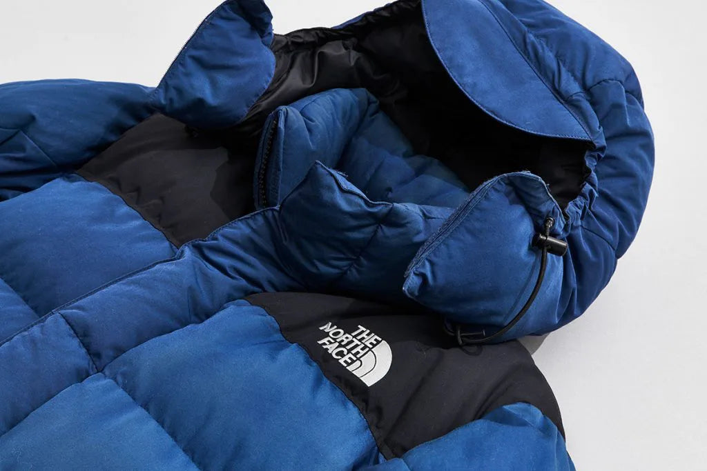 A blue The North Face down jacket with hood