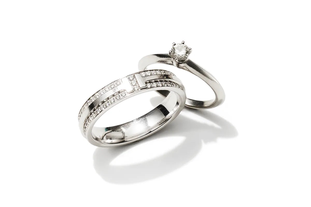 A pair of a diamond wedding band and an engagement ring