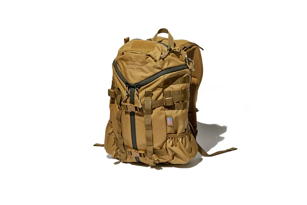 Brown military backpack by Mystery Ranch