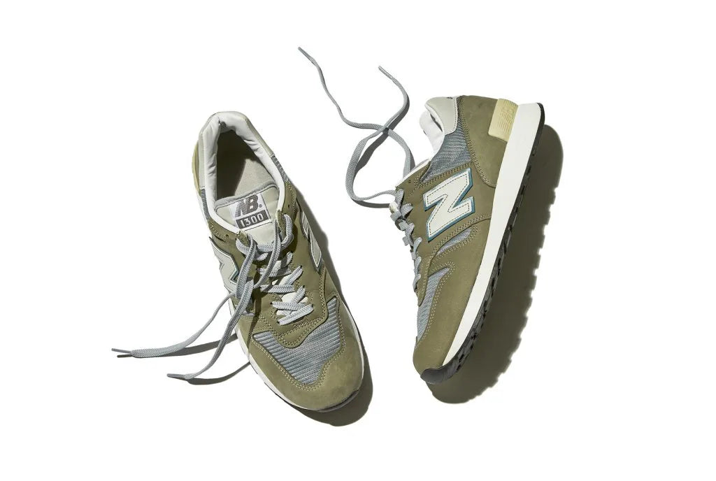 A pair of light green New Balance sneakers with the logo "N" on the side