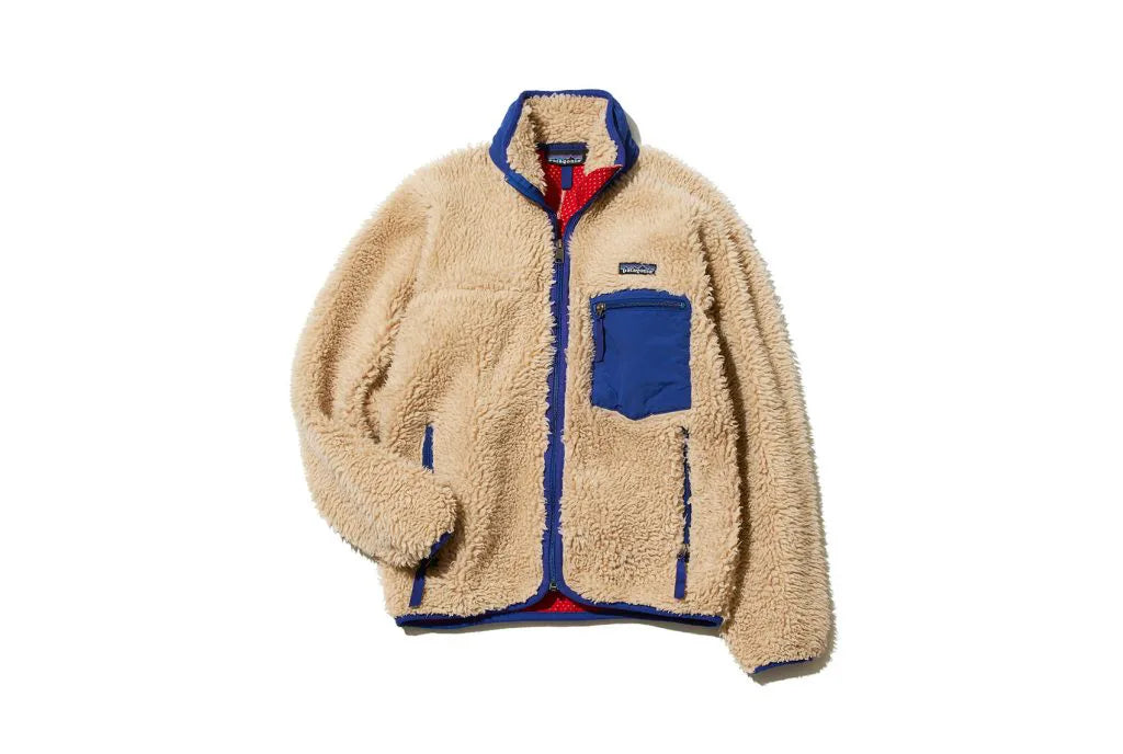 Beige fleece zip-up jacket with blue trim and a blue chest pocket