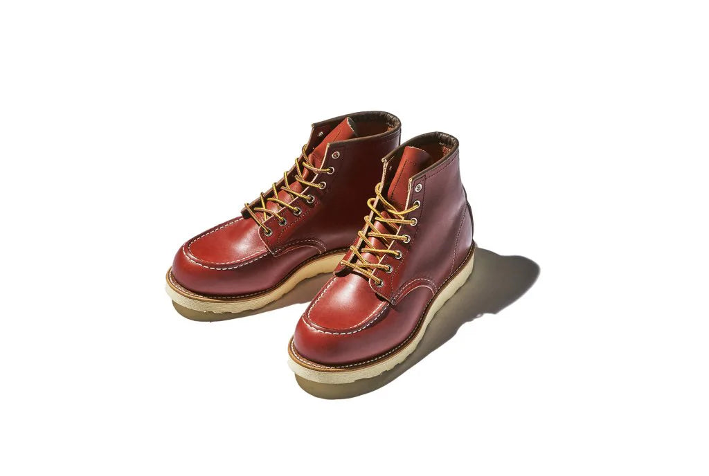 Red laced leather boots with a light sole