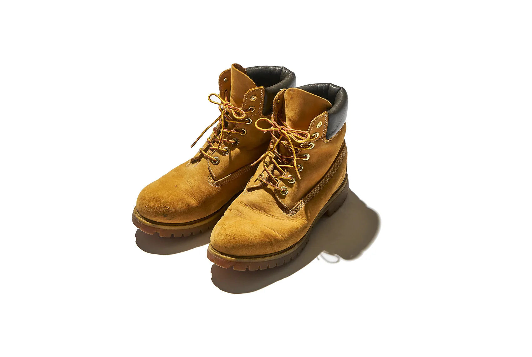 Pair of tan leather lace-up work boots with black padded collars