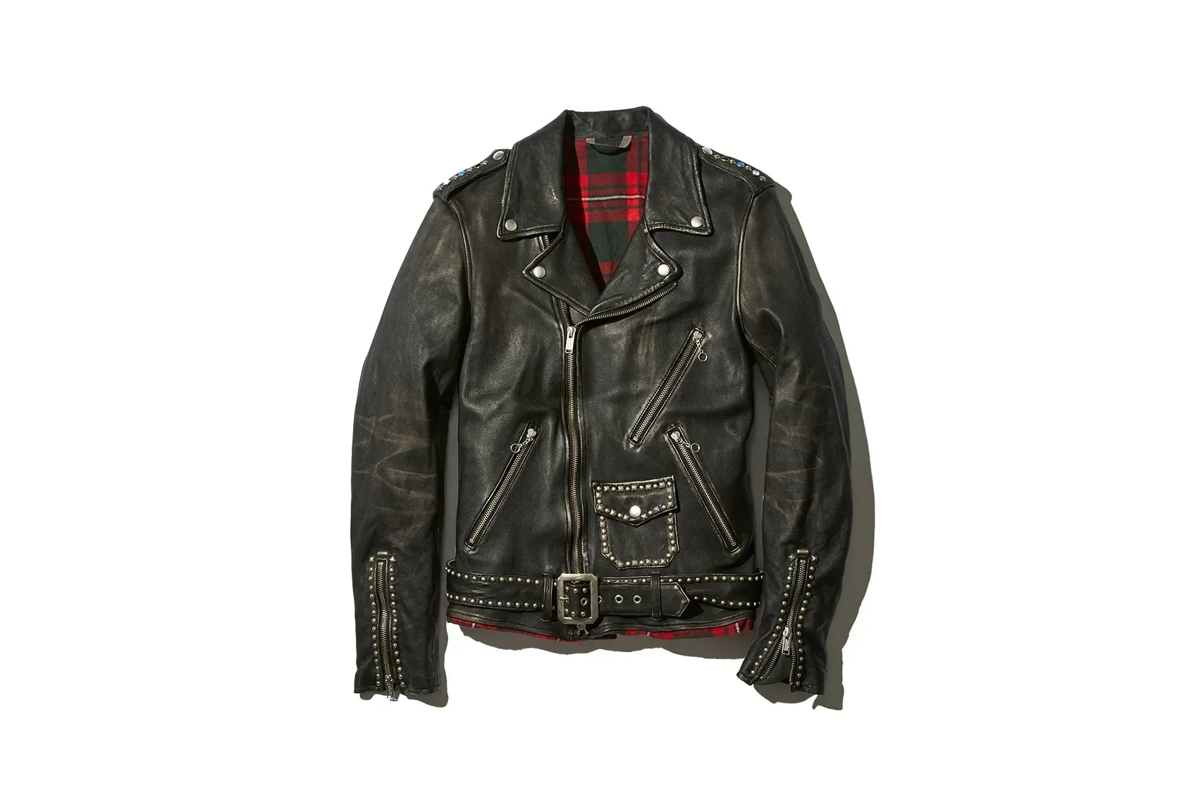 Black leather motorcycle jacket with red plaid lining, multiple zippered pockets, studs, and a belted waist