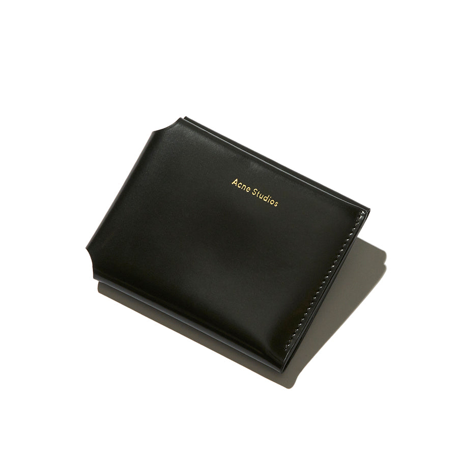 Woman is holding a YSL black wallet