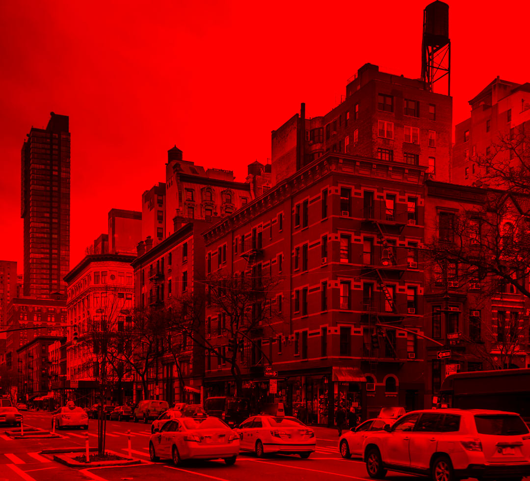 City street with buildings and cars under a red filter