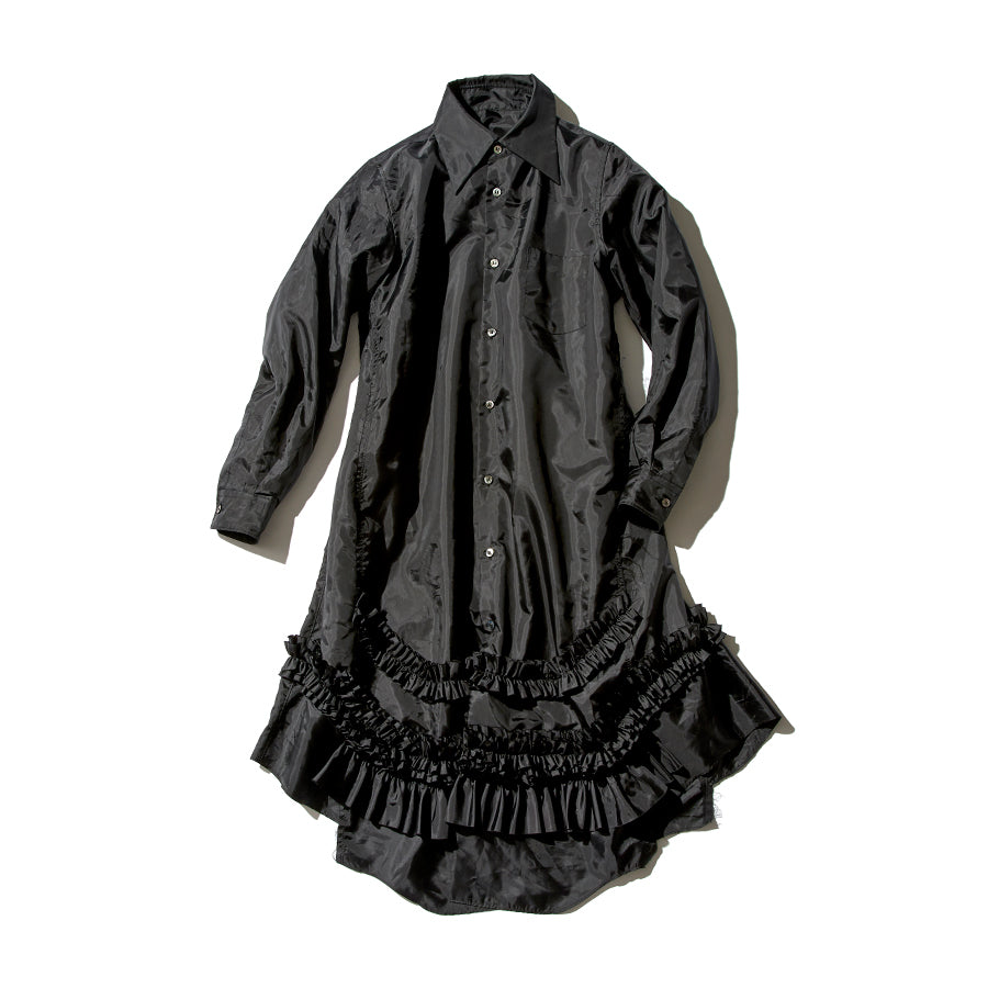 CDG black long-sleeve button-front shirt dress with a pointed collar and layered ruffle trim at the hem on a white background.