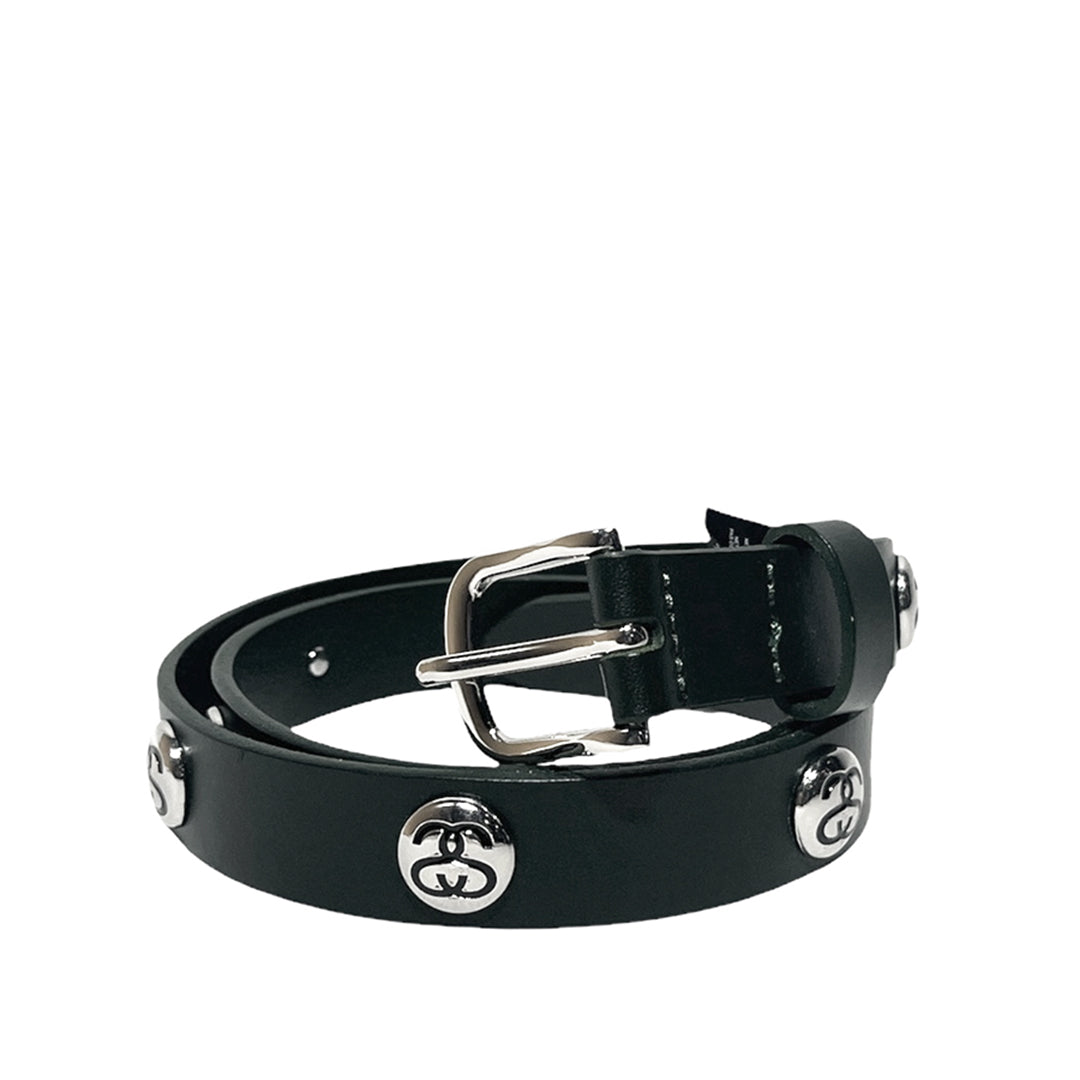 A black leather belt with silver-tone hardware, featuring decorative interlocking 'Stussy logo' studs and a polished buckle, displayed on a clean white background.